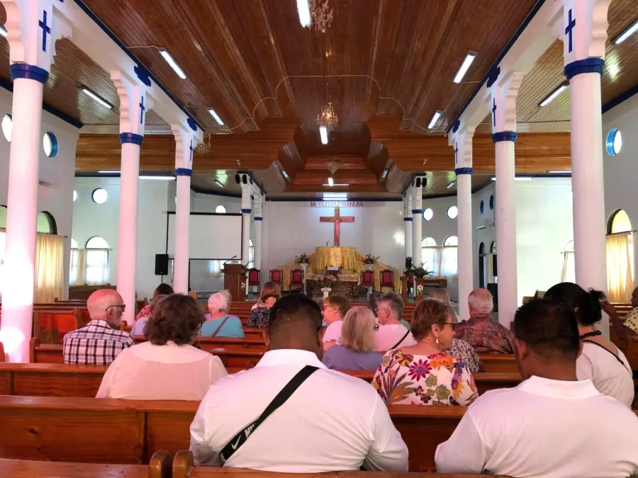 Congregation seated inside bright church sanctuary