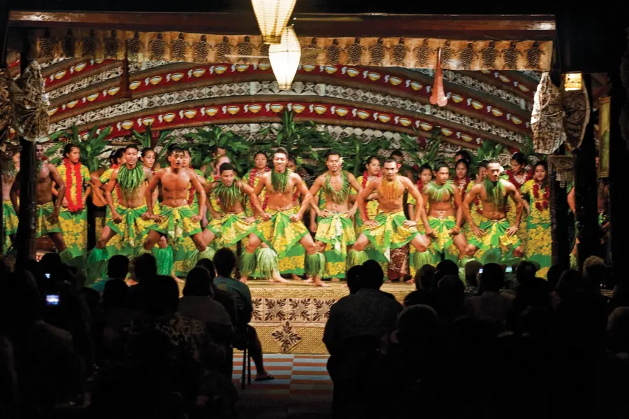 Polynesian dancers performing on a decorated stage