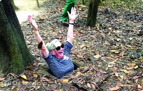Tourist emerging from Cu Chi Tunnels entrance