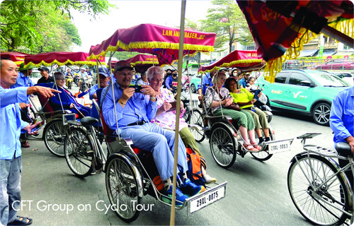 Tourists riding cyclos on busy city street