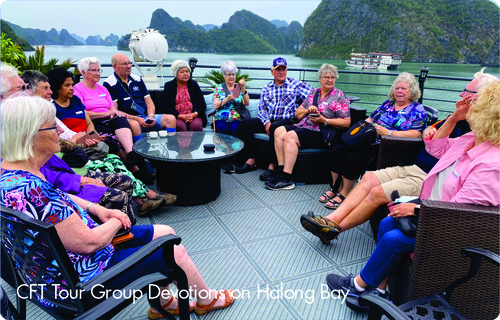 Tour group seated on boat in Ha Long Bay