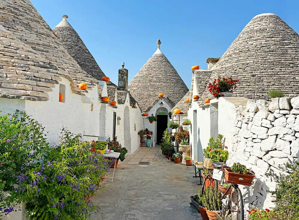 Traditional trulli houses along narrow stone lane