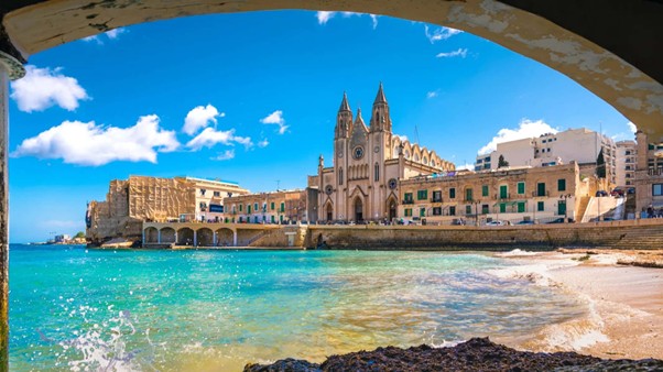 Coastal cathedral overlooking turquoise Mediterranean bay