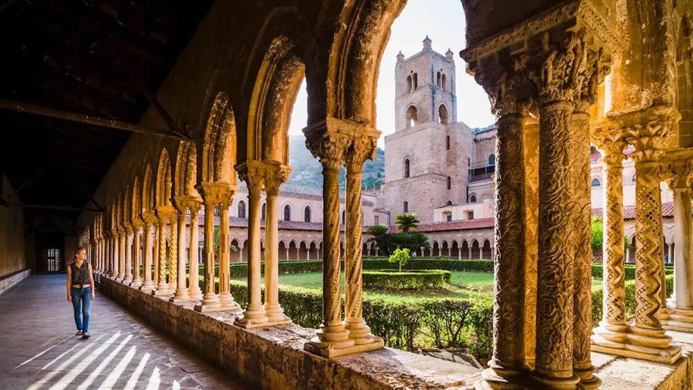 Historic cloister with ornate columns and courtyard garden
