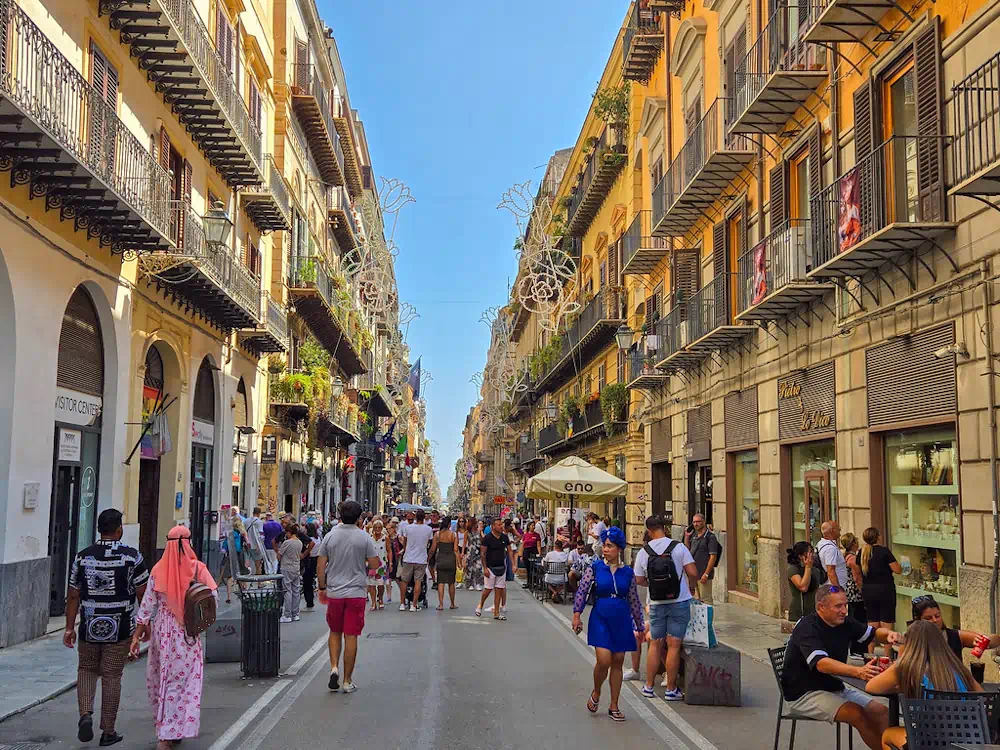 Busy European street with balconies and outdoor dining