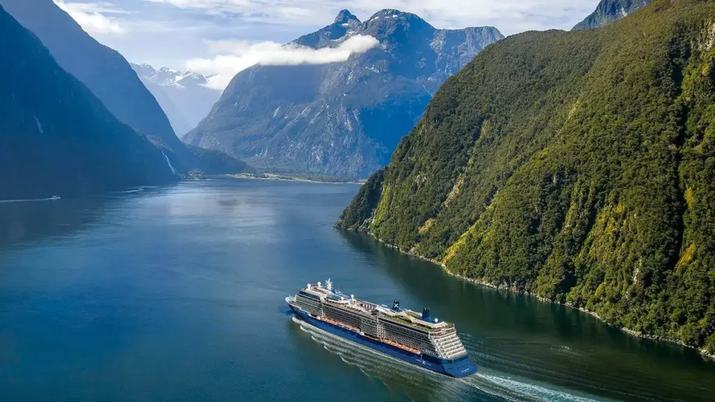 Cruise ship sailing through scenic fjord