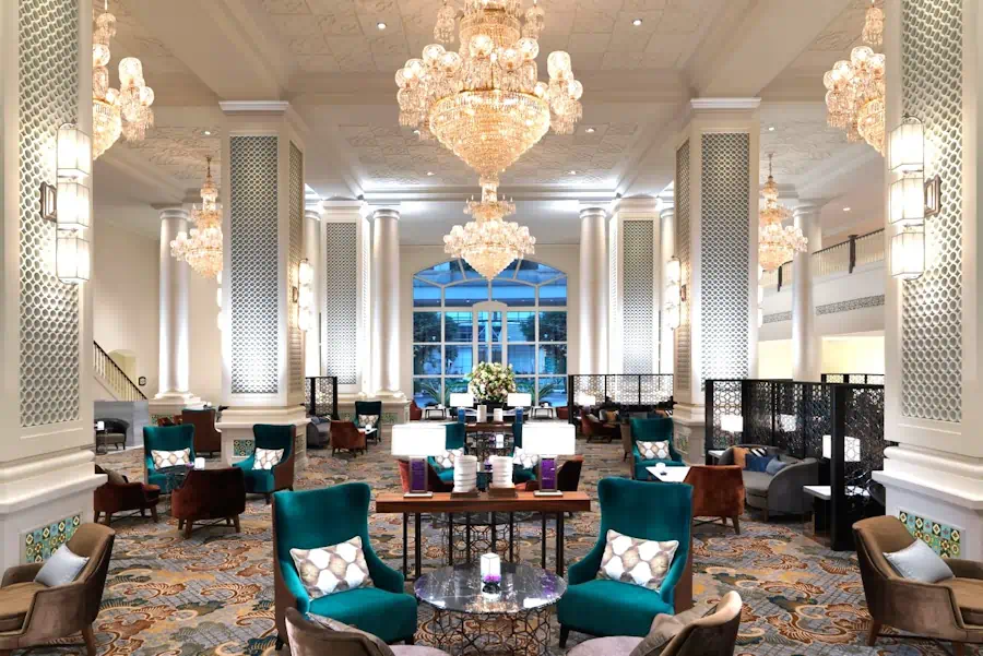 Grand hotel lobby with chandeliers and columns