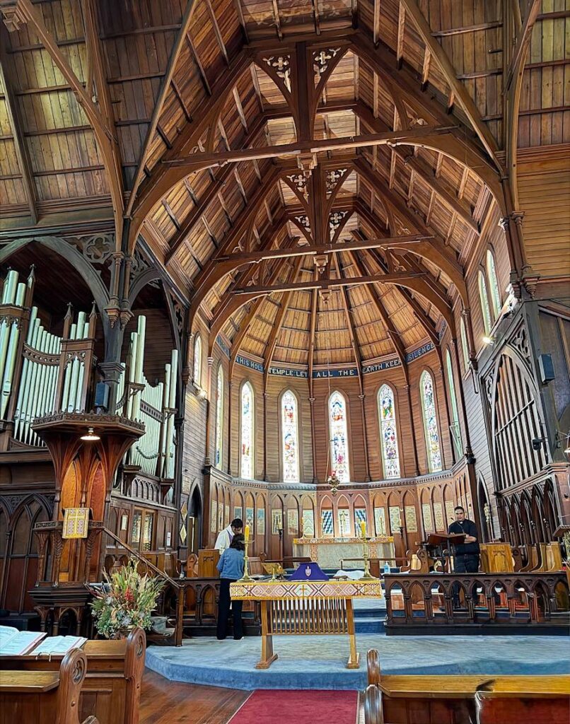 Wooden church interior with stained glass and altar