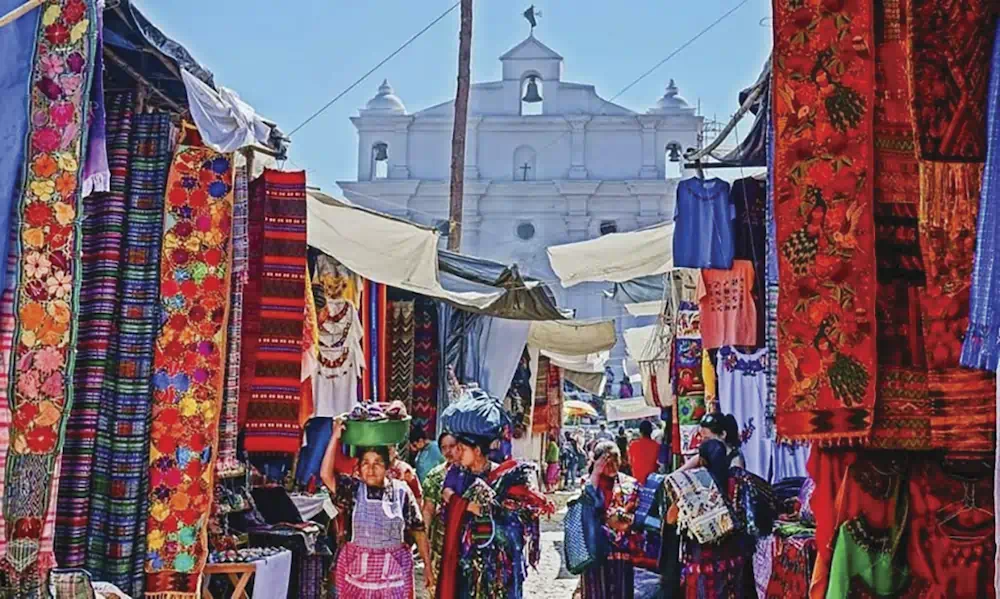 Colourful textile market with church in background