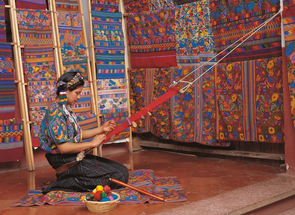 Woman weaving colourful traditional textiles indoors