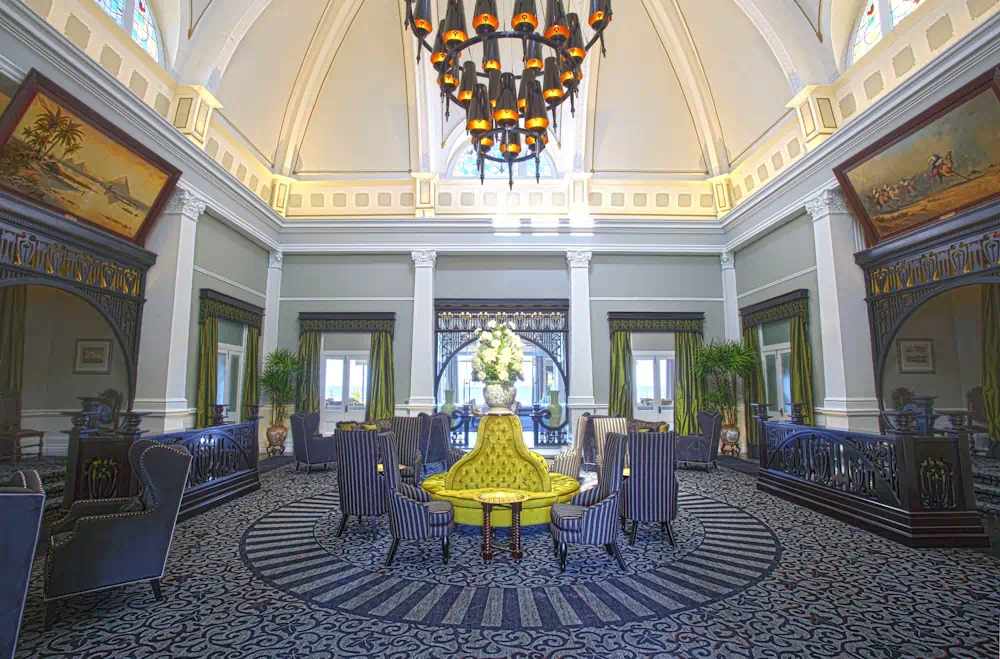 Elegant hotel lobby with chandelier and green sofa