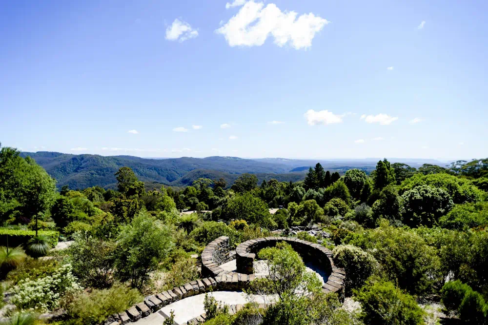 Stone circular garden overlooking lush mountain landscape