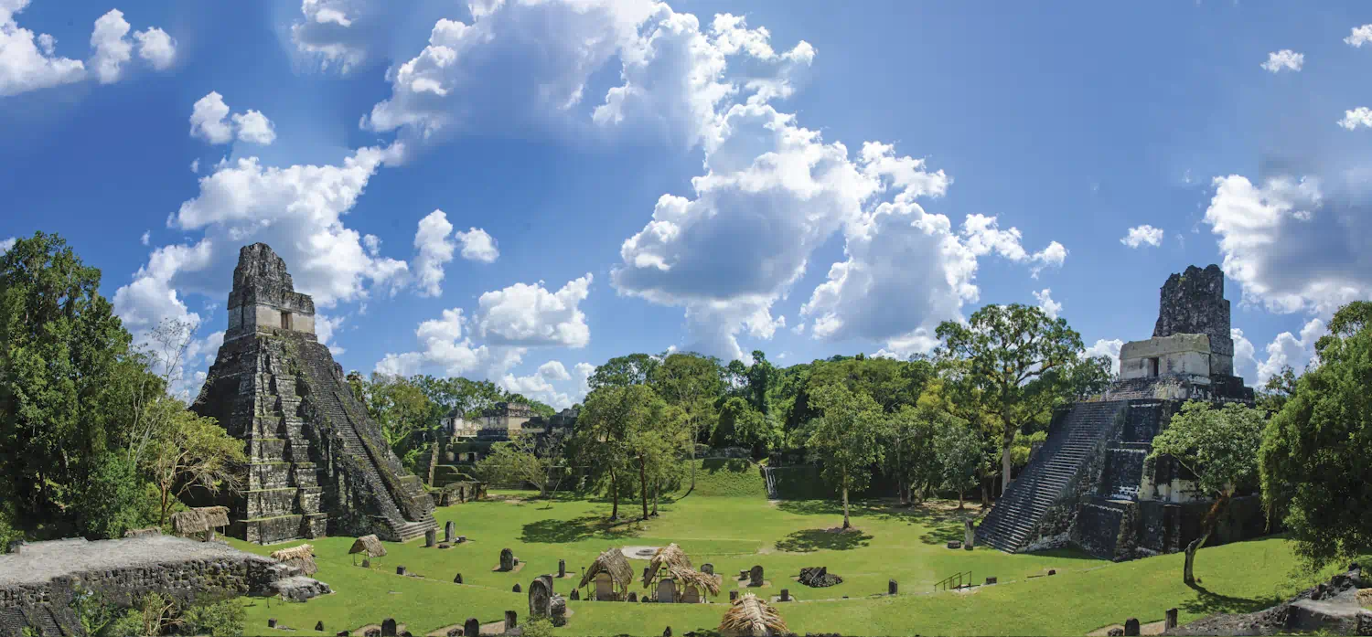 Ancient Mayan temples rising above jungle canopy