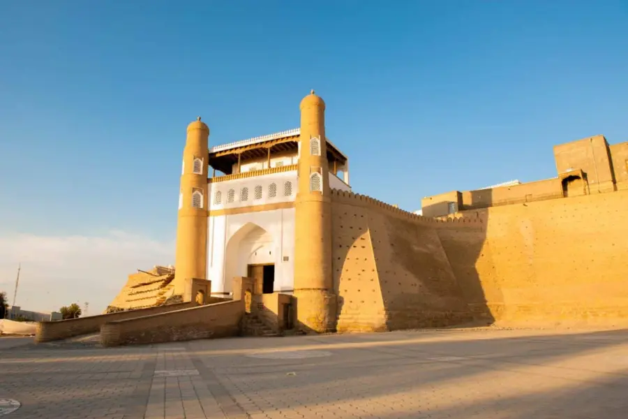 Sunlit historic fort gateway with twin towers