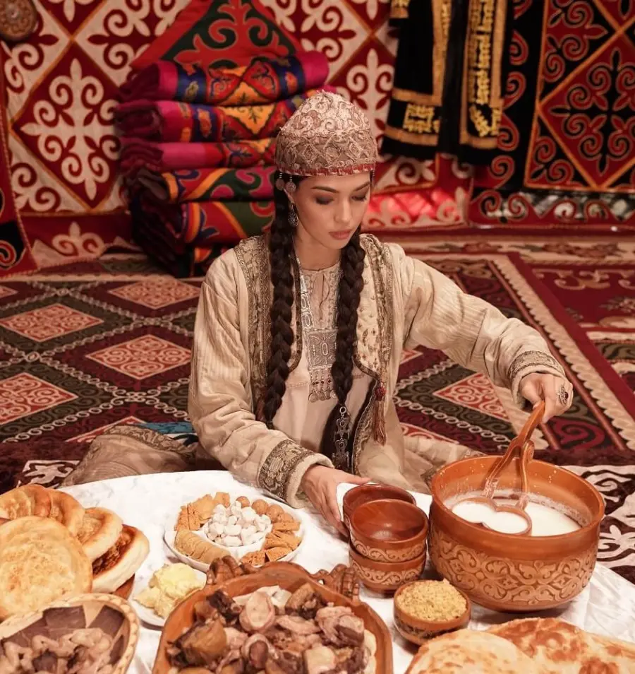 Woman serving traditional food in richly decorated interior