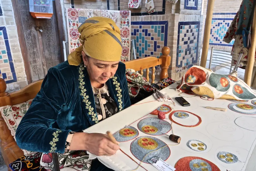 Woman hand-embroidering colourful circular textile patterns
