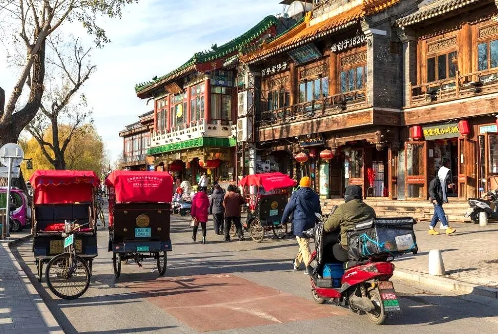 Pedicabs and scooters on a historic Chinese street