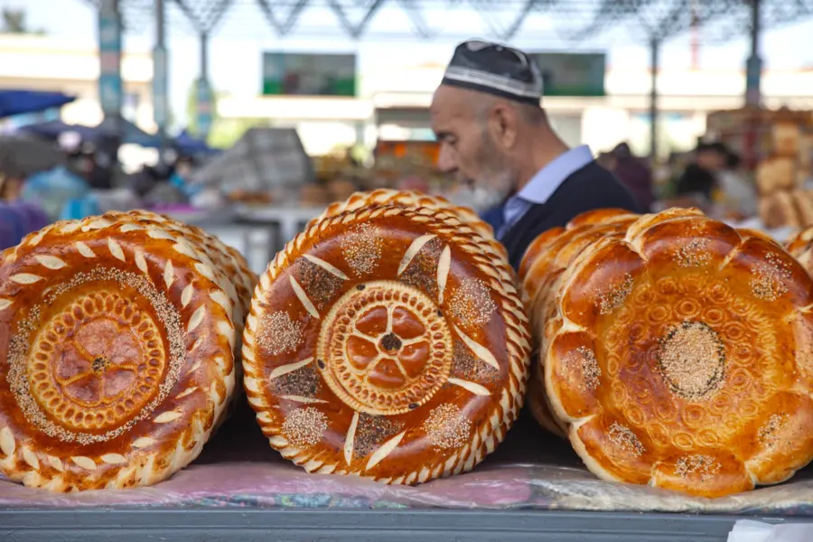 Decorative round loaves displayed at a busy market