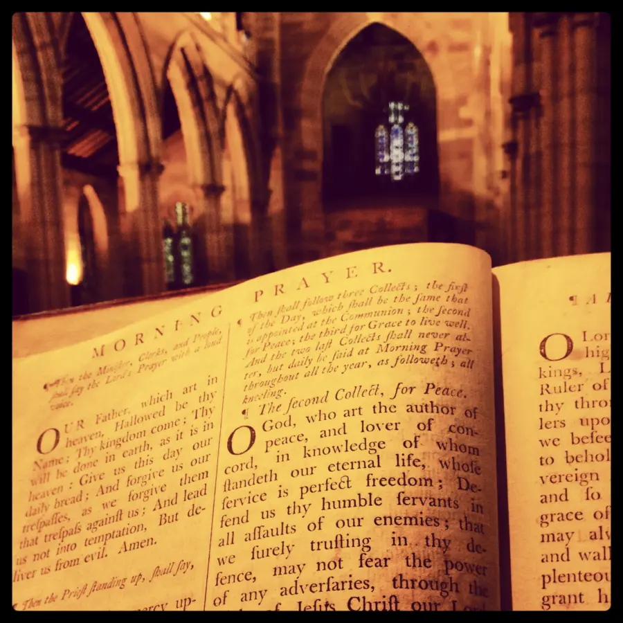 Open prayer book inside a Gothic church