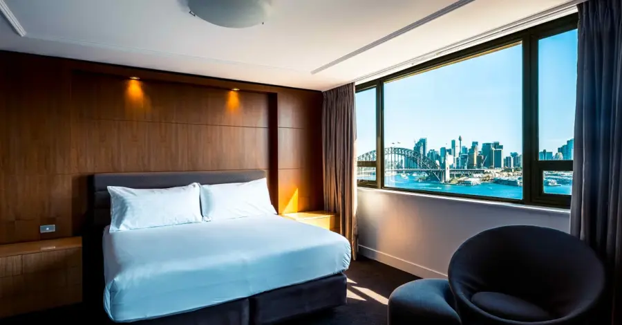 Hotel bedroom overlooking Sydney Harbour Bridge and skyline
